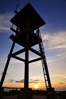 Life guard tower on sunset sky