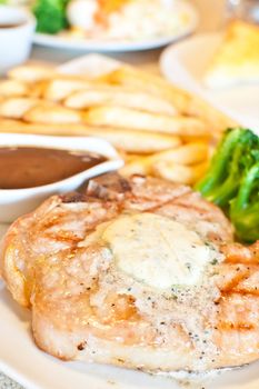 juicy grilled Pork chops and gravy with fried potato broccoli