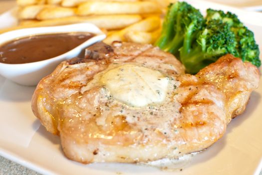 juicy grilled Pork chops and gravy with fried potato broccoli