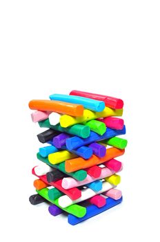 Stack of colorfull plasticine on white background