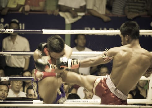 BANGKOK, THAILAND- OCTOBER 04 : Unidentified boxers compete in Thai Fight: Muay Thai Charity on October 04, 2012 at Rajadamnern Stadium in Bangkok, Thailand