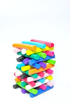 Stack of colorfull plasticine on white background