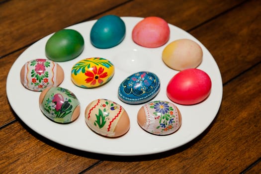 Colorful dyed Easter eggs on a while egg tray.