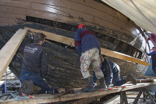 HELLEVOETSLUIS,HOLLAND-AUGUST 31:Unidentified people bending wood in the dry dock for renovation of russian frigat,on August 31,2012 in Hellevoetsluis,Holland.This renovation is only once in 13 years.