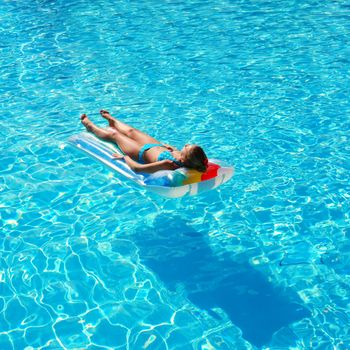 Girl in resort swimming pool