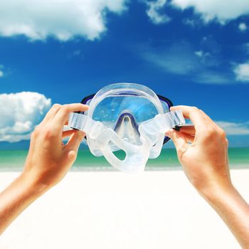 Snorkel equipment against beach and sky