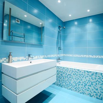 Modern luxury bathroom blue interior. No brandnames or copyright objects. 