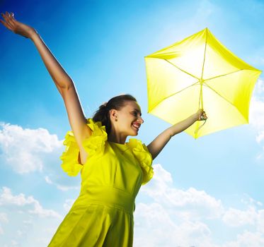 Woman holding umbrella against sun and sky