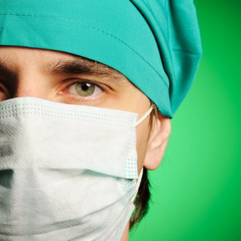 Surgeon in mask over green