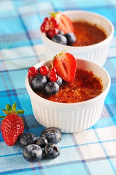 Creme brulee (cream brulee, burnt cream) with fruits and berries