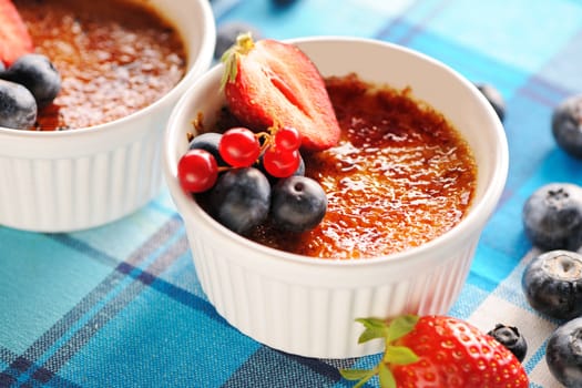 Creme brulee (cream brulee, burnt cream) with fruits and berries