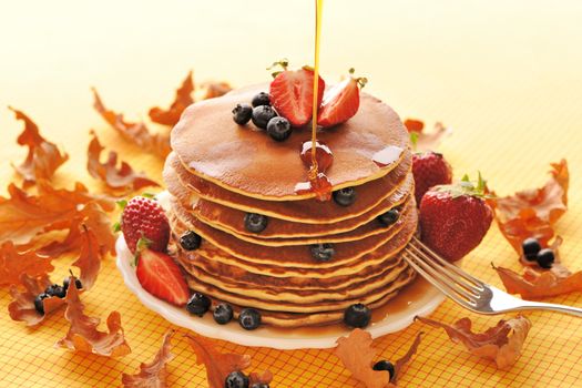 Delicious freshly prepared pancakes with strawberry and blueberries