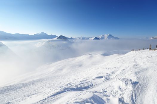 Mountains in clouds with snow in winter, Val-d'Isere, Alps, France