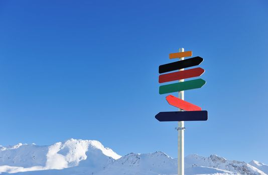 Arrow sign at mountains with snow in winter, Val-d'Isere, Alps, France