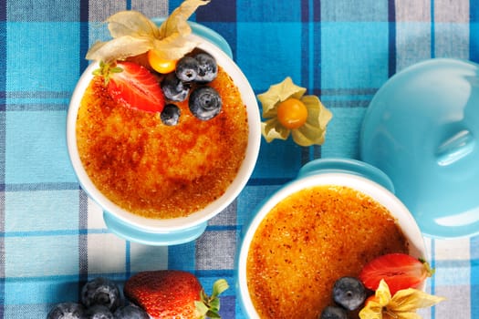 Creme brulee (cream brulee, burnt cream) with fruits and berries