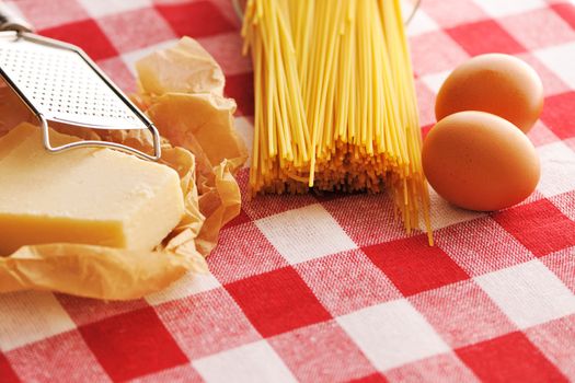 Pasta and ingredients over red cloth