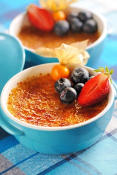 Creme brulee (cream brulee, burnt cream) with fruits and berries