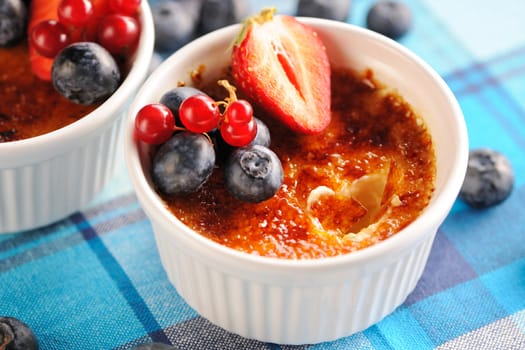 Creme brulee (cream brulee, burnt cream) with fruits and berries