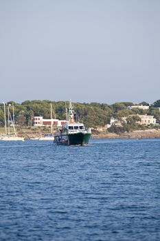 fishing boat in summer outside in sea at harbour background