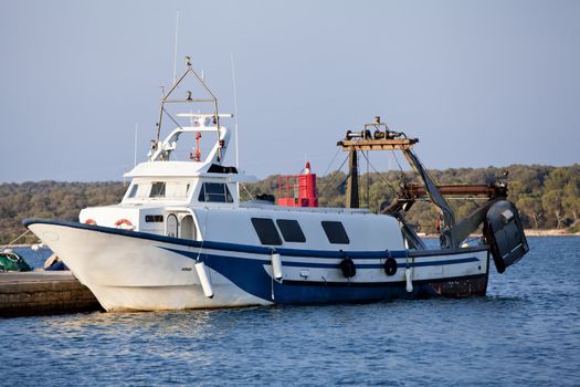 fishing boat in summer outside in sea at harbour background