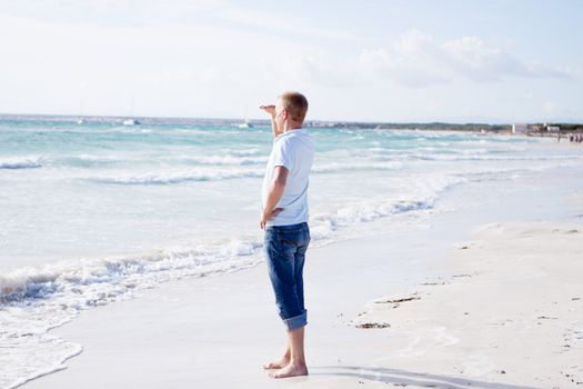 young man is relaxing on beach in summer vacation freedom