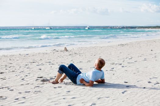 young man is relaxing on beach in summer vacation freedom