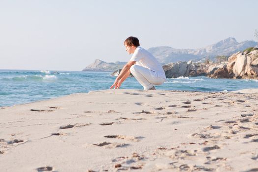 young man is relaxing on beach in summer vacation freedom