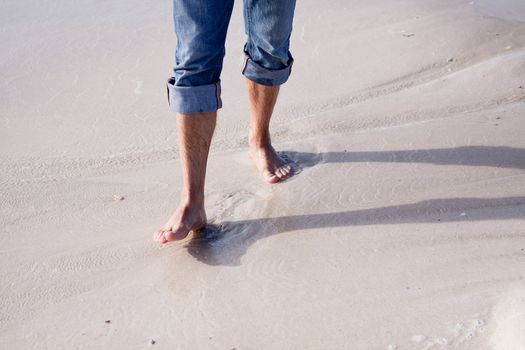 barefoot in sand and water on beach  in summer holidays relaxing