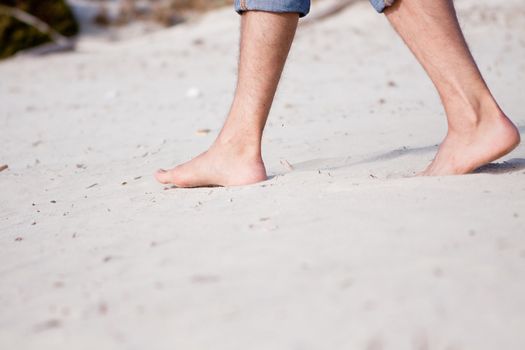 barefoot in sand and water on beach  in summer holidays relaxing