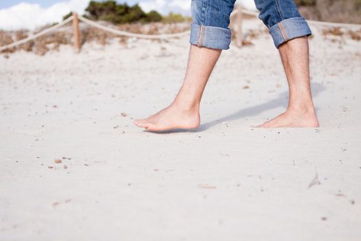 barefoot in sand and water on beach  in summer holidays relaxing