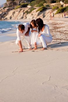 happy young family with daughter on beach in summer lifestyle