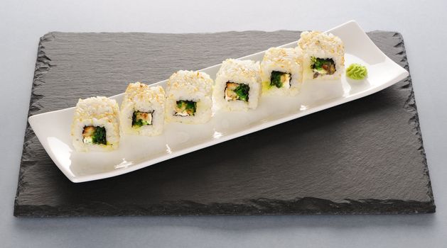 Sushi rolls on a slate plate