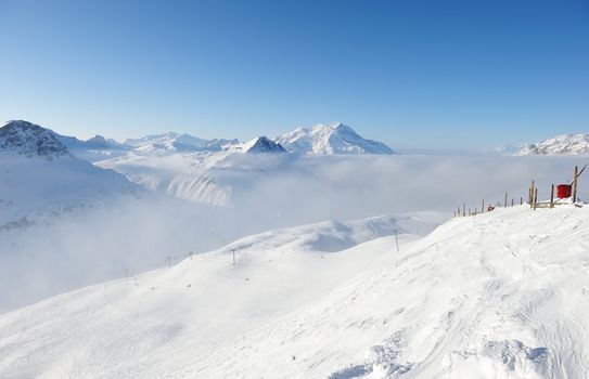 Mountains in clouds with snow in winter, Val-d'Isere, Alps, France