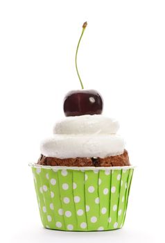 Cupcake with whipped cream and cherry isolated on white