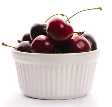 Cherry in bowl isolated on white