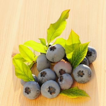 Blueberry with leafs on wooden table