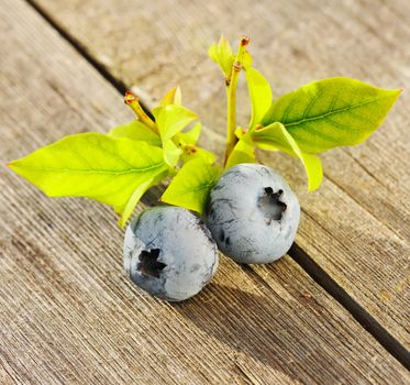 Blueberry with leafs on wooden table