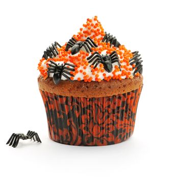 Halloween cupcake with whipped cream and decoration isolated on white