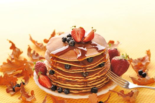 Delicious freshly prepared pancakes with strawberry and blueberries