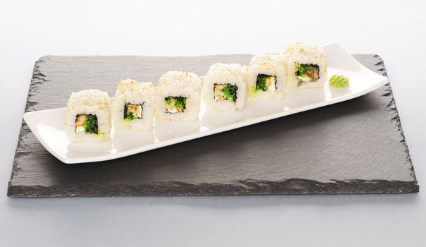 Sushi rolls on a slate plate
