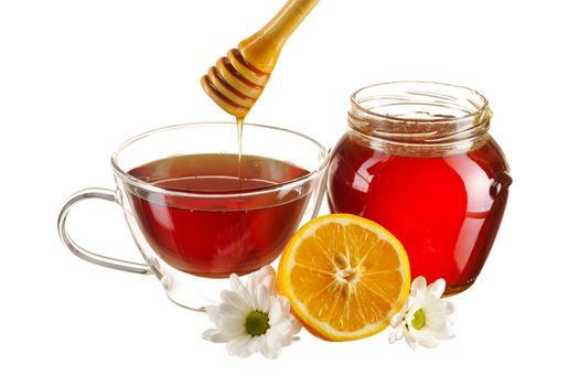 Jar of honey and tea cup isolated over white