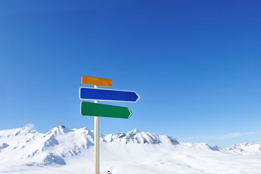 Arrow sign at mountains with snow in winter, Val-d'Isere, Alps, France