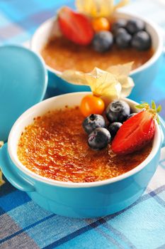 Creme brulee (cream brulee, burnt cream) with fruits and berries