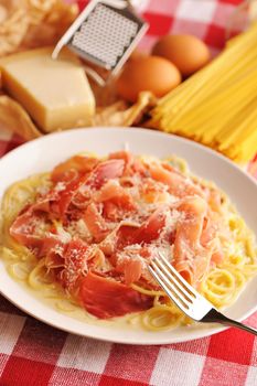 Pasta carbonara over red cloth