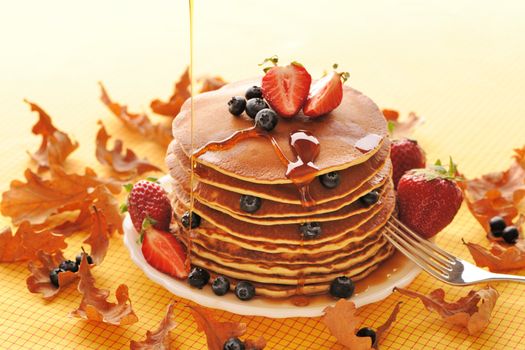 Delicious freshly prepared pancakes with strawberry and blueberries