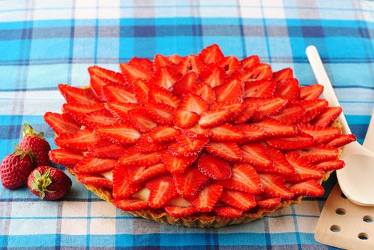 Homemade strawberry tart on table