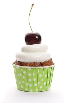 Cupcake with whipped cream and cherry isolated on white