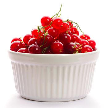 Redcurrant in bowl isolated on white