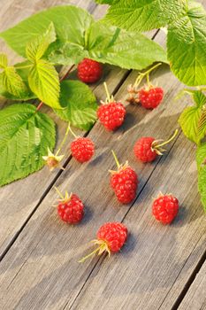 Raspberry with leafs on wooden table