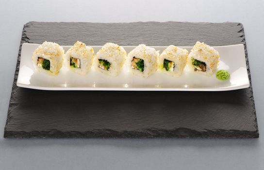 Sushi rolls on a slate plate